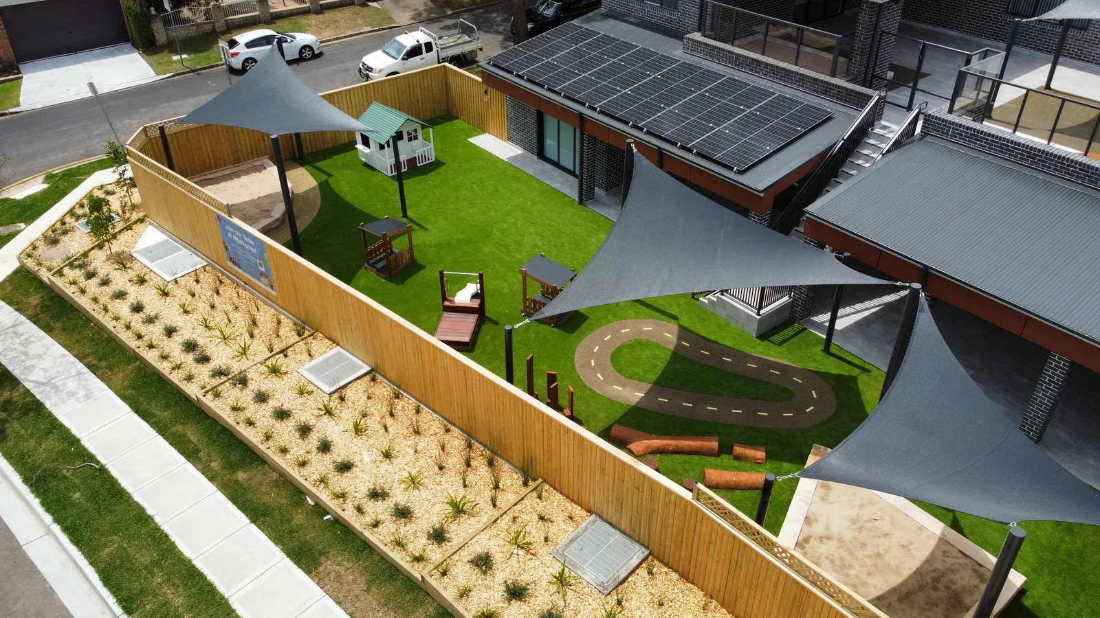 Aerial view of Bradbury childcare playspace with synthetic lawn and rubber soft-fall