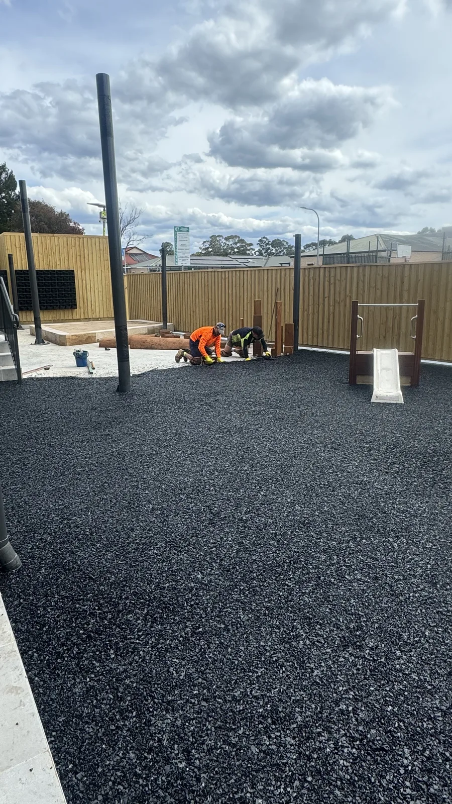 Rubber softfall being installed at a childcare play space — JL Turf Group