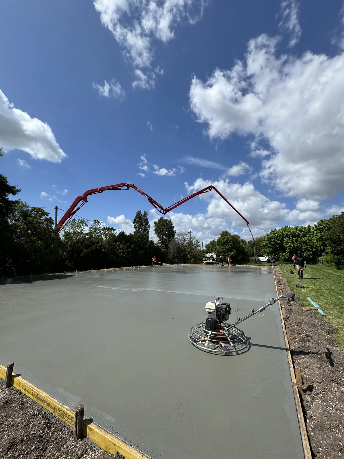 Power-trowel finishing of a new court base slab — JL Turf Group civil works